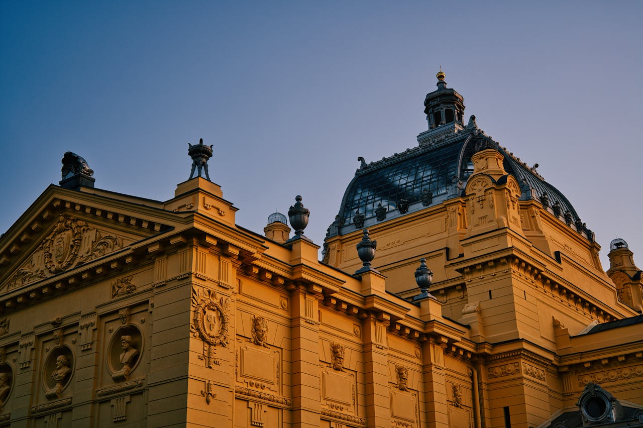 Ornate historic building with detailed architecture under a clear evening sky.
